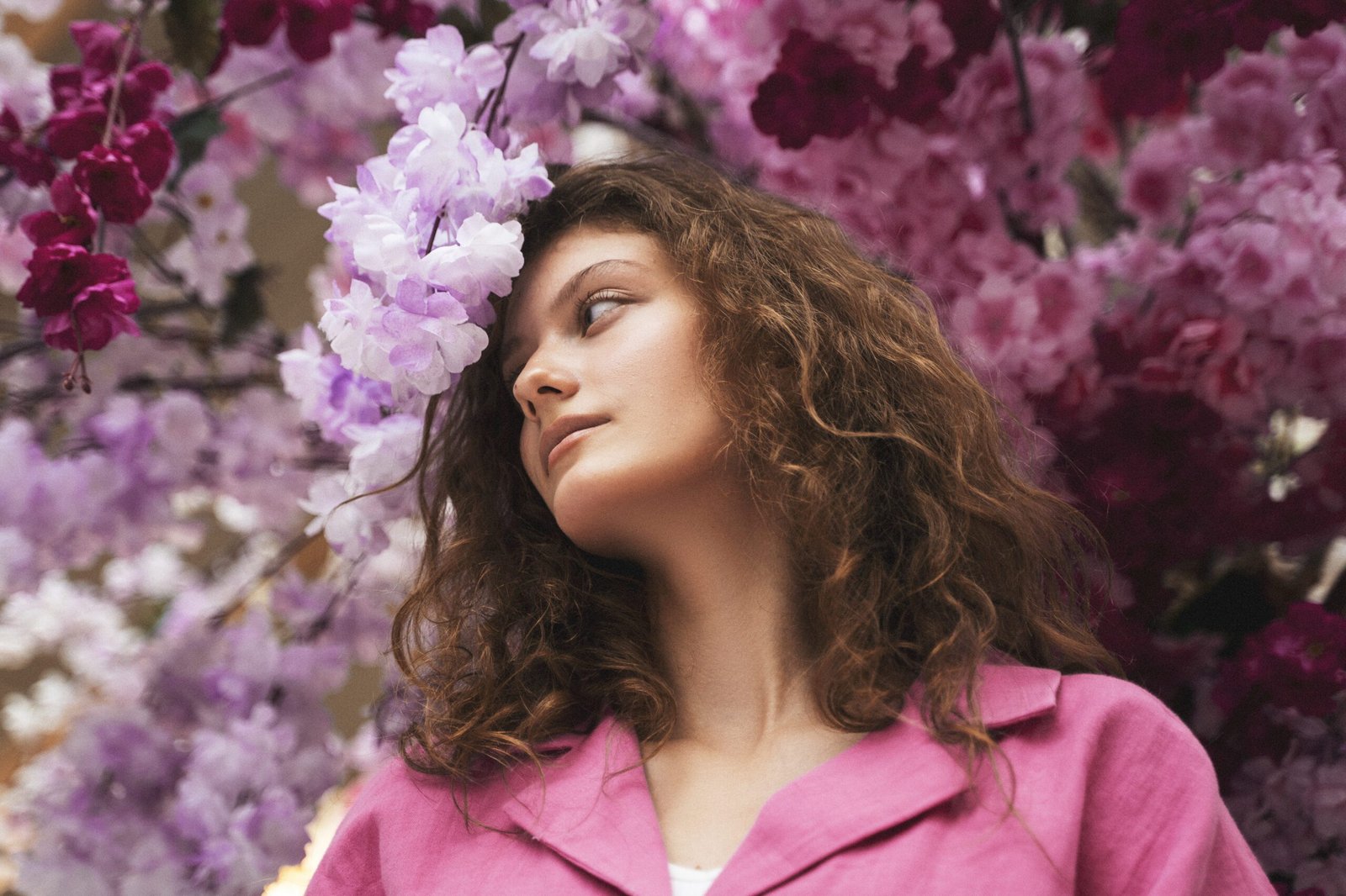 low angle woman posing with flowers